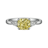 Cushion cut yellow lab-grown diamond ring with white side stones on platinum band