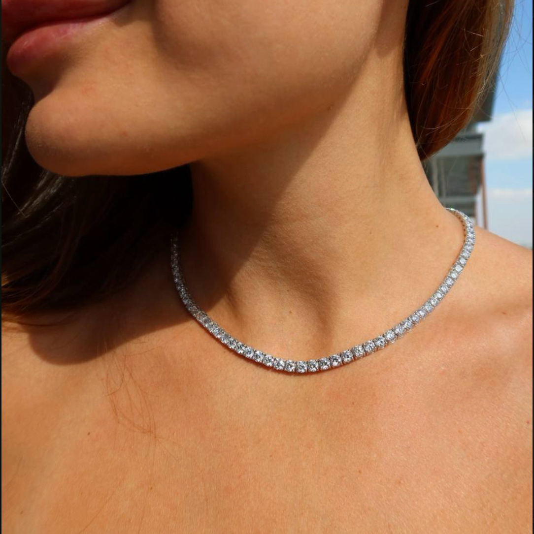 Woman wearing a lab-grown diamond tennis necklace in natural outdoor light