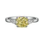 Cushion cut yellow lab-grown diamond ring with white side stones on platinum band