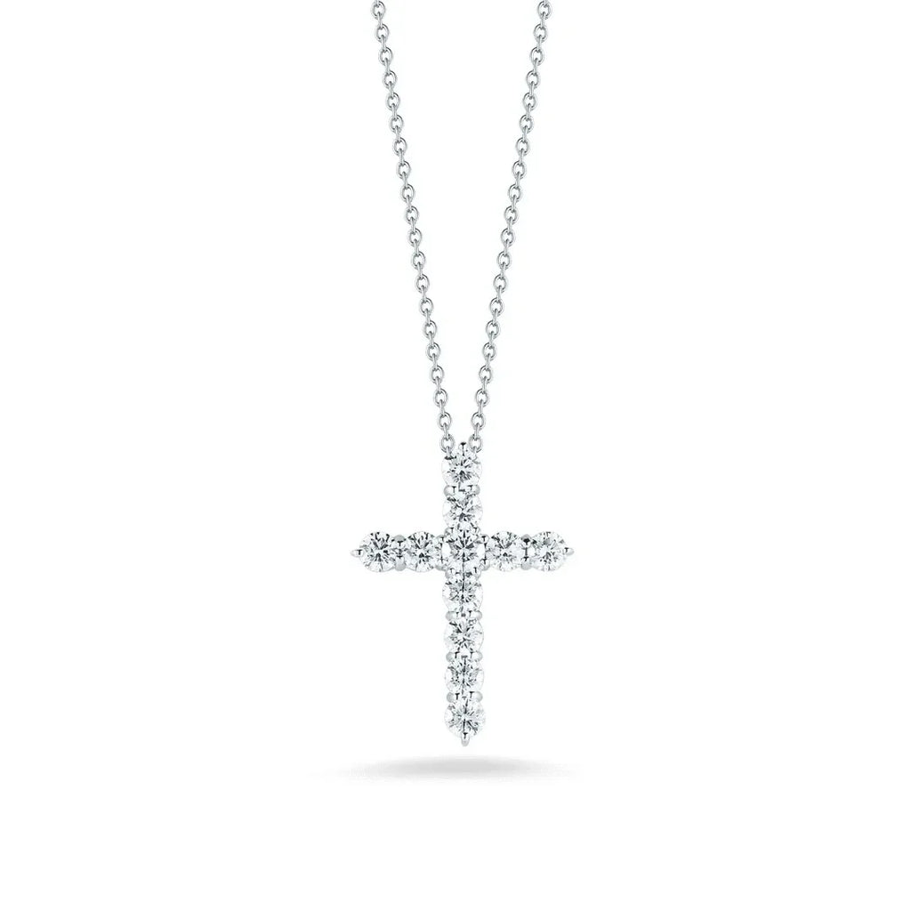 Lab-grown diamond cross pendant necklace on a silver chain, isolated on white background.
