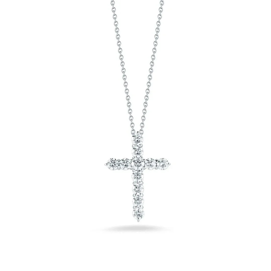Lab-grown diamond cross pendant necklace on a silver chain, isolated on white background.