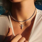 Woman wearing lab-grown diamond tennis necklace and diamond cross pendant necklace