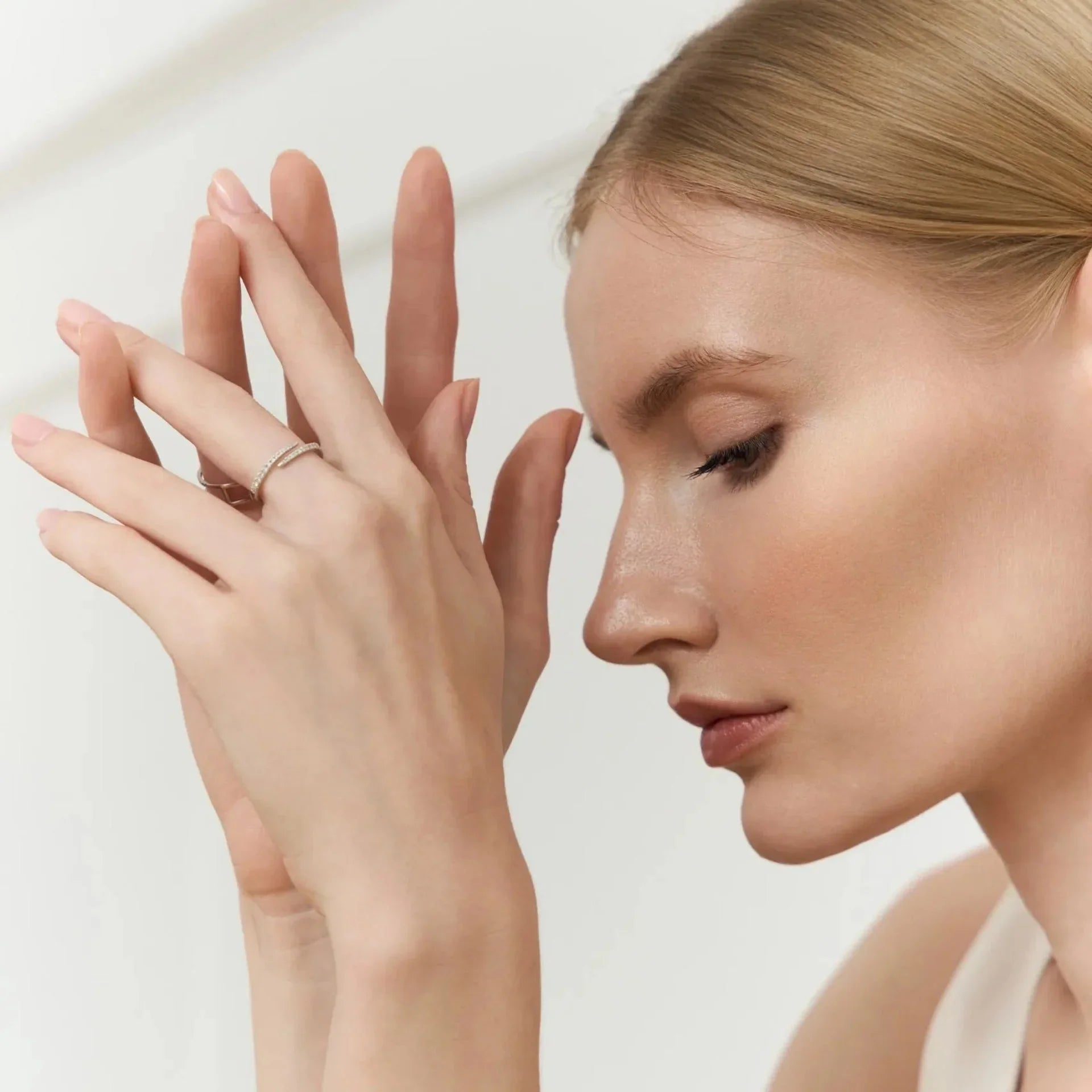Woman wearing delicate lab-grown diamond ring, showcasing sustainable jewelry elegance
