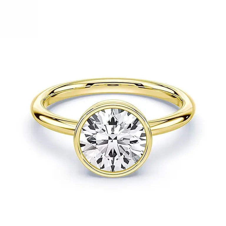 Gold ring with a round lab-grown diamond solitaire on white background