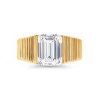 Emerald cut lab-grown diamond ring with grooved yellow gold band on white background
