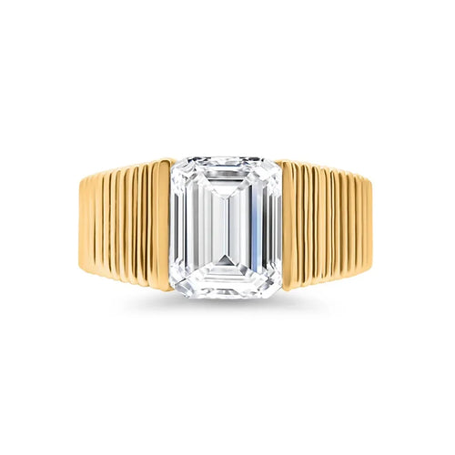 Emerald cut lab-grown diamond ring with grooved yellow gold band on white background