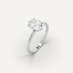 Oval lab-grown diamond solitaire ring in white gold setting on plain background