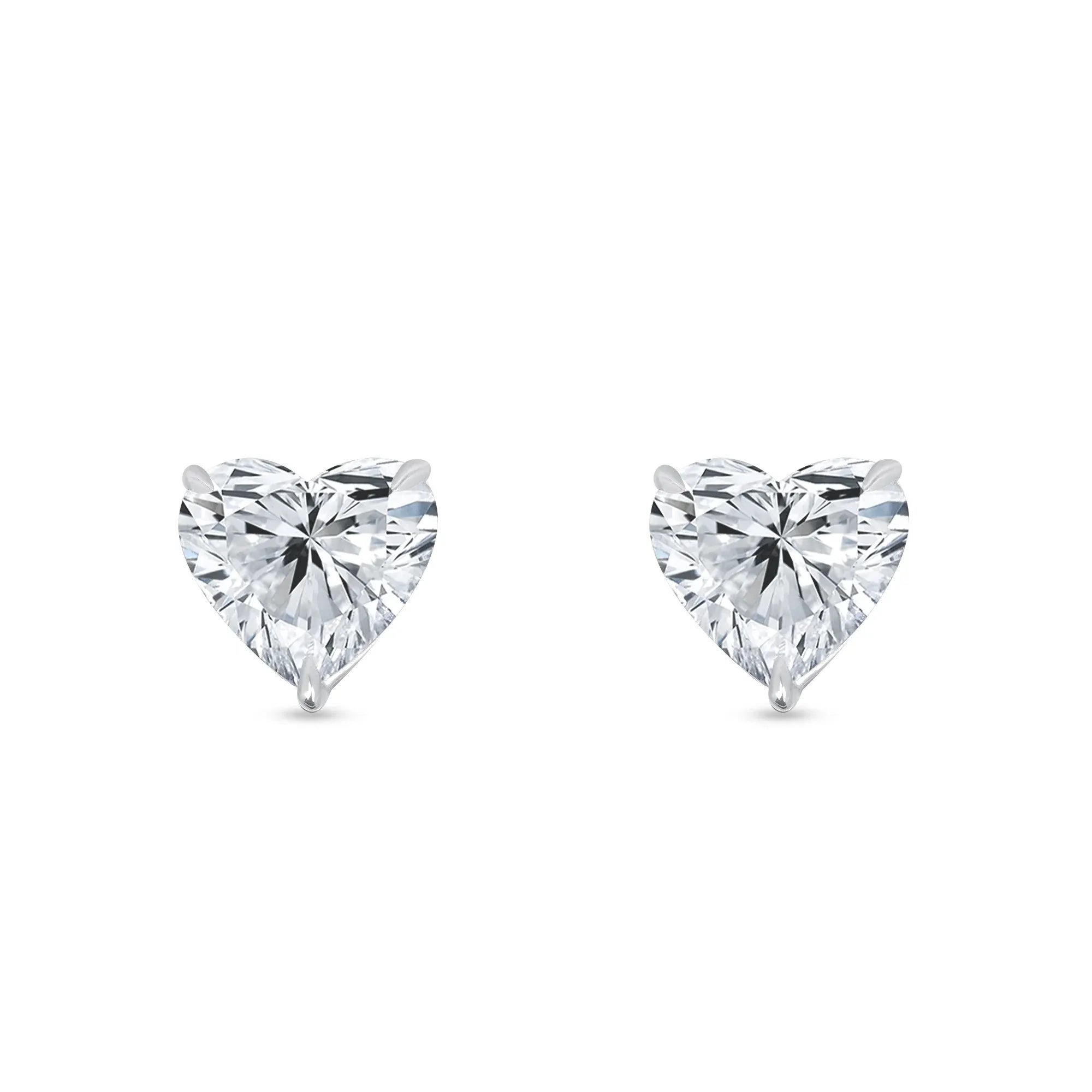 Heart-shaped lab-grown diamond stud earrings with white gold prongs on white background
