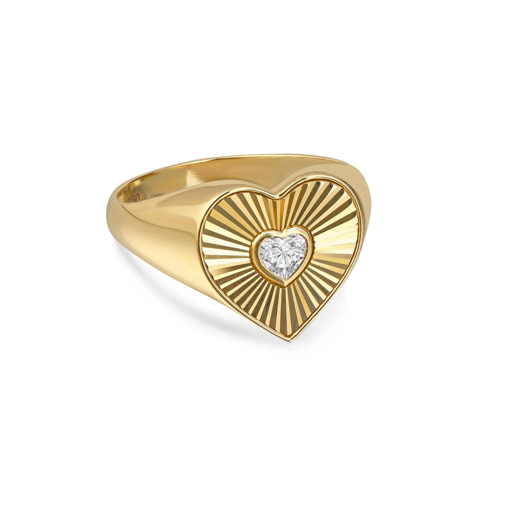 Gold heart-shaped ring with a central lab-grown diamond and radiant engraved pattern
