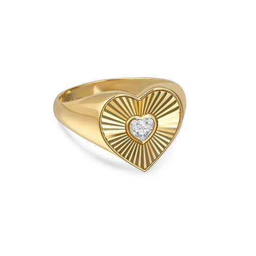 Gold heart-shaped ring with a central lab-grown diamond and radiant engraved pattern